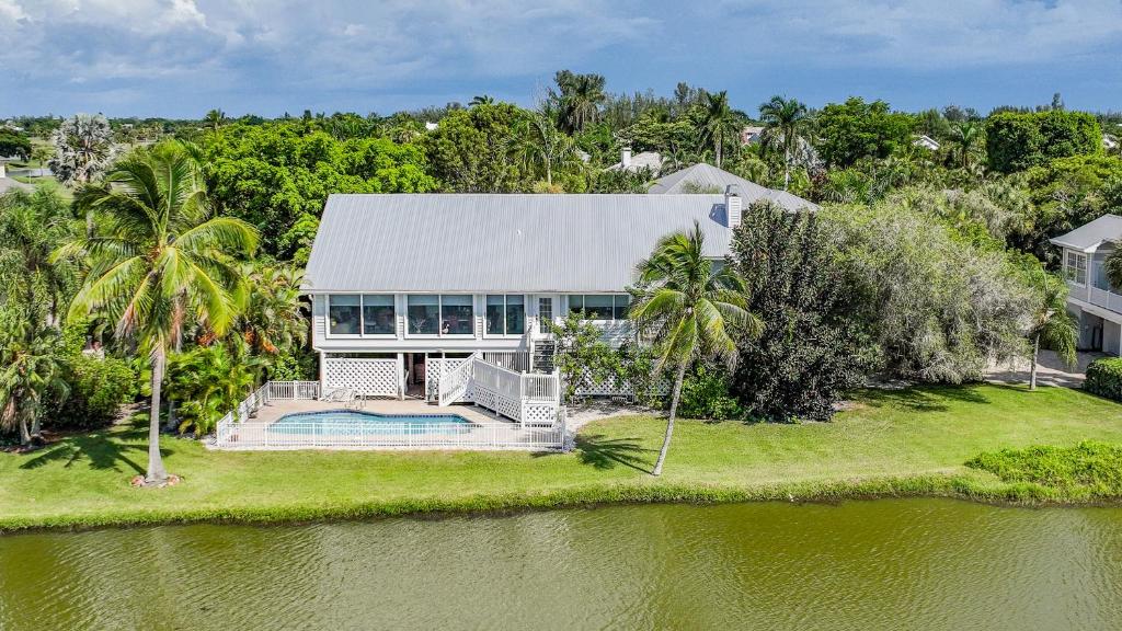 an aerial view of a house with a swimming pool at PEARL OF SANIBEL-Brand New to Rentals! in Sanibel