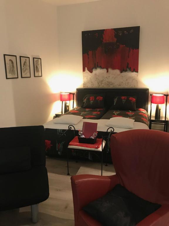 a bedroom with a bed and a couch at Villa 't Haasduin in Wijk aan Zee