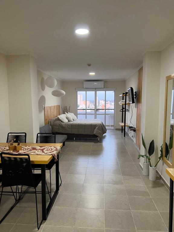 a living room with a bed and a table at Departamento en zona centro in Resistencia