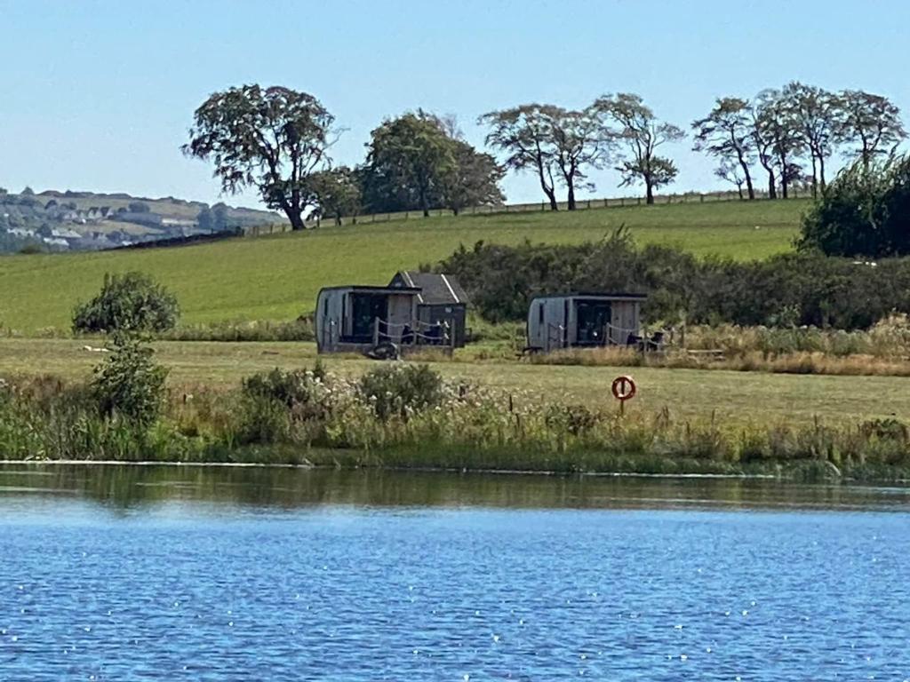 two campgrounds next to a body of water at Couston Lakes Resorts in Bathgate