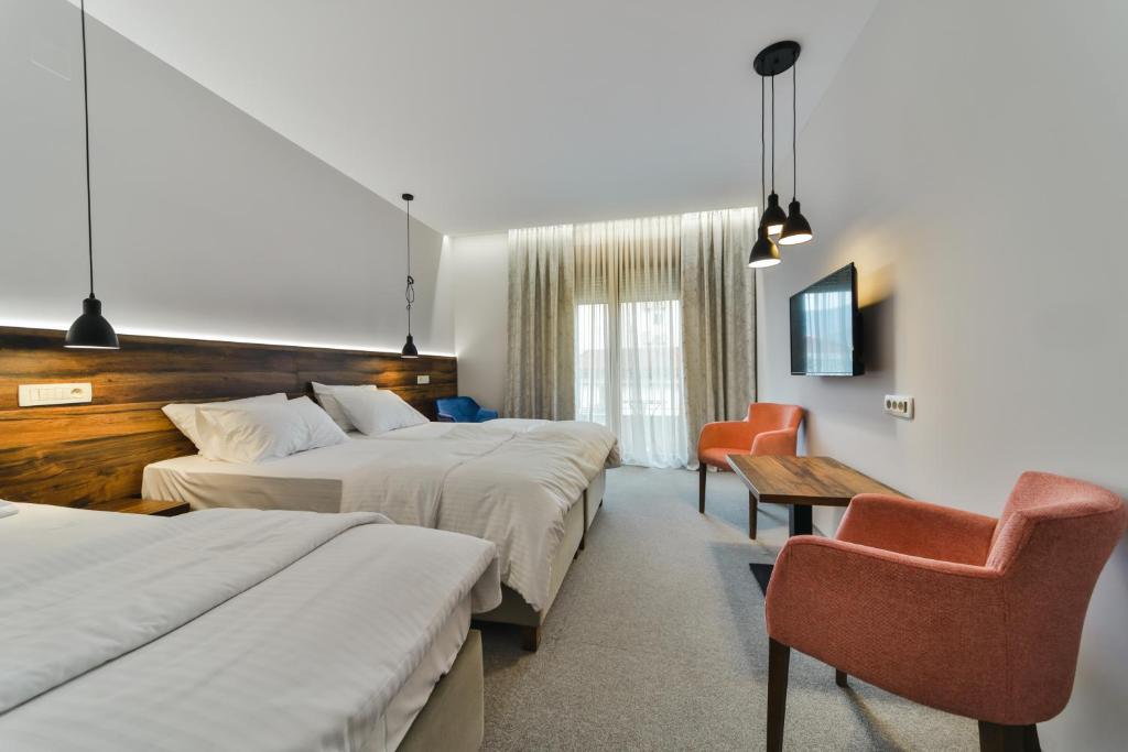 Postel nebo postele na pokoji v ubytování Hotel Vladimir