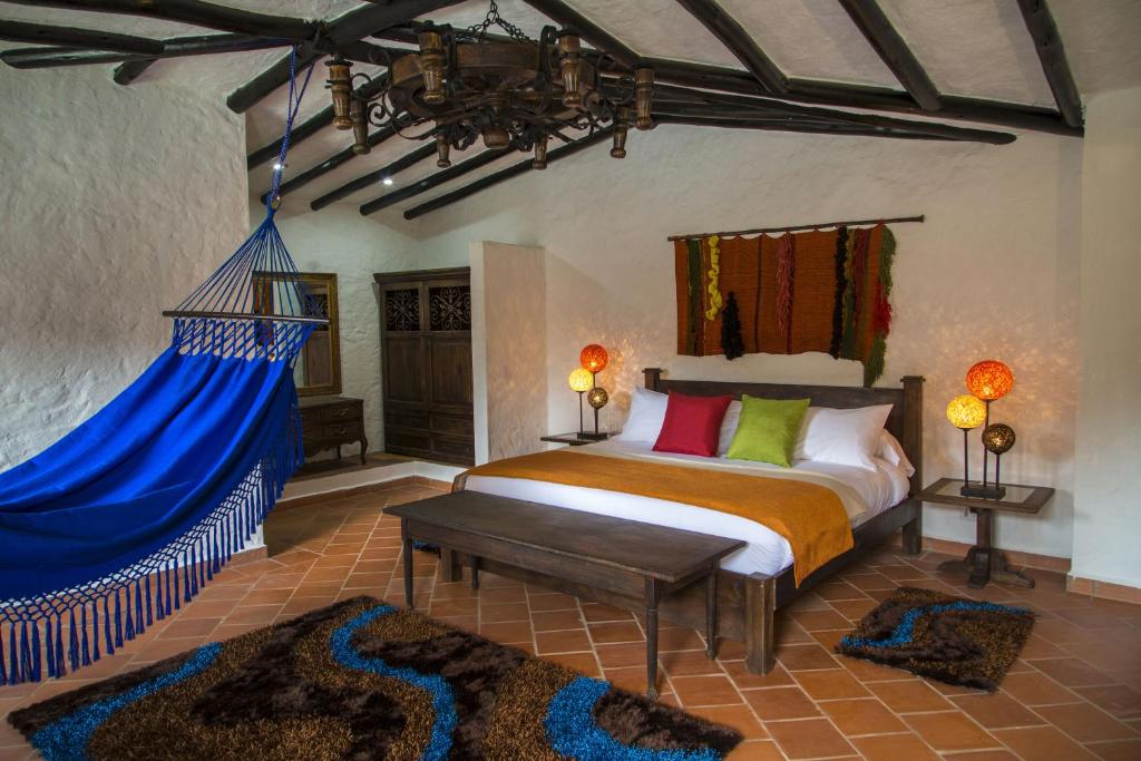 a bedroom with a bed with a blue canopy at Casona Quesada in Suesca