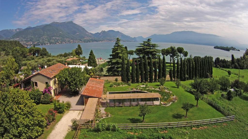 an aerial view of a house with a garden and a lake at Agriturismo La Breda in San Felice del Benaco