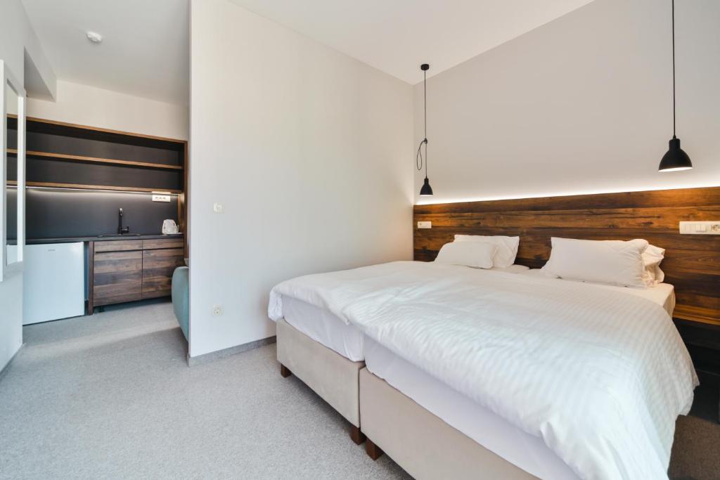 Postel nebo postele na pokoji v ubytování Hotel Vladimir