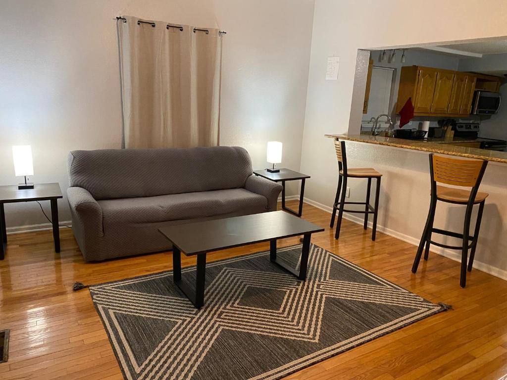 a living room with a couch and a table at Cozy house with large free parking on premises in Springfield