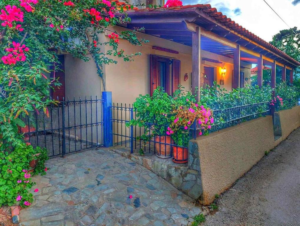 a house with potted plants on a balcony at Elisavet's House in Platanias