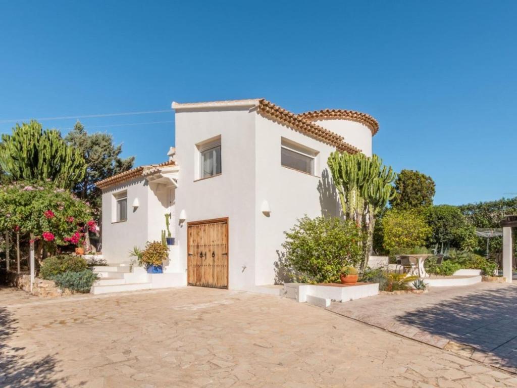 a villa with a gate and a driveway at Scenic Villa, Costa Blanca in Denia