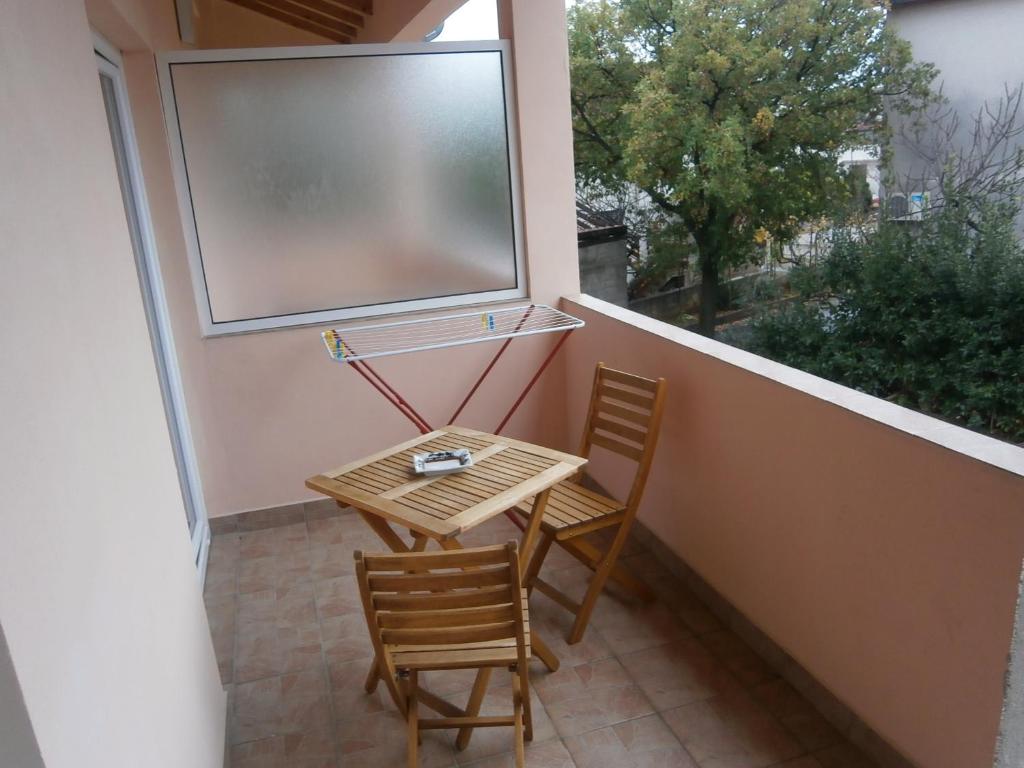 a small table and two chairs on a balcony at Apartment Maja in Vodice