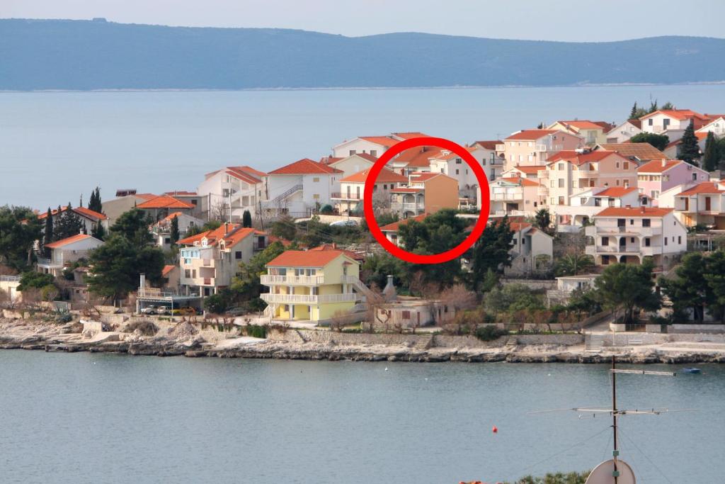 a red circle in the middle of a city with houses at Apartments by the sea Businci, Ciovo - 4668 in Trogir