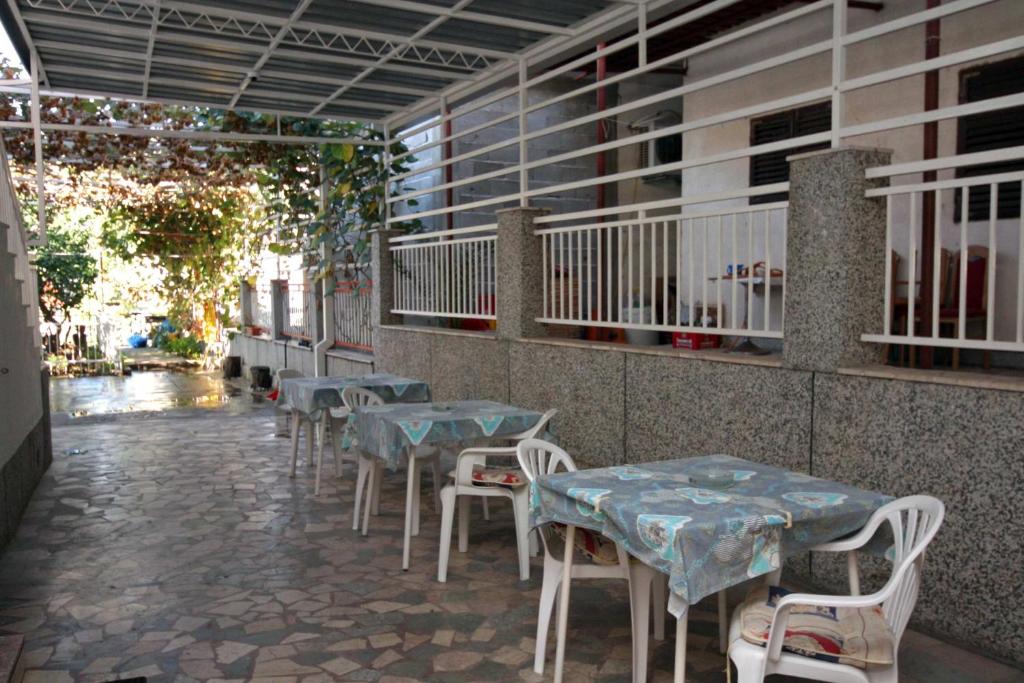 a row of tables and chairs on a patio at Apartments with parking space Podaca, Makarska - 4747 in Podaca