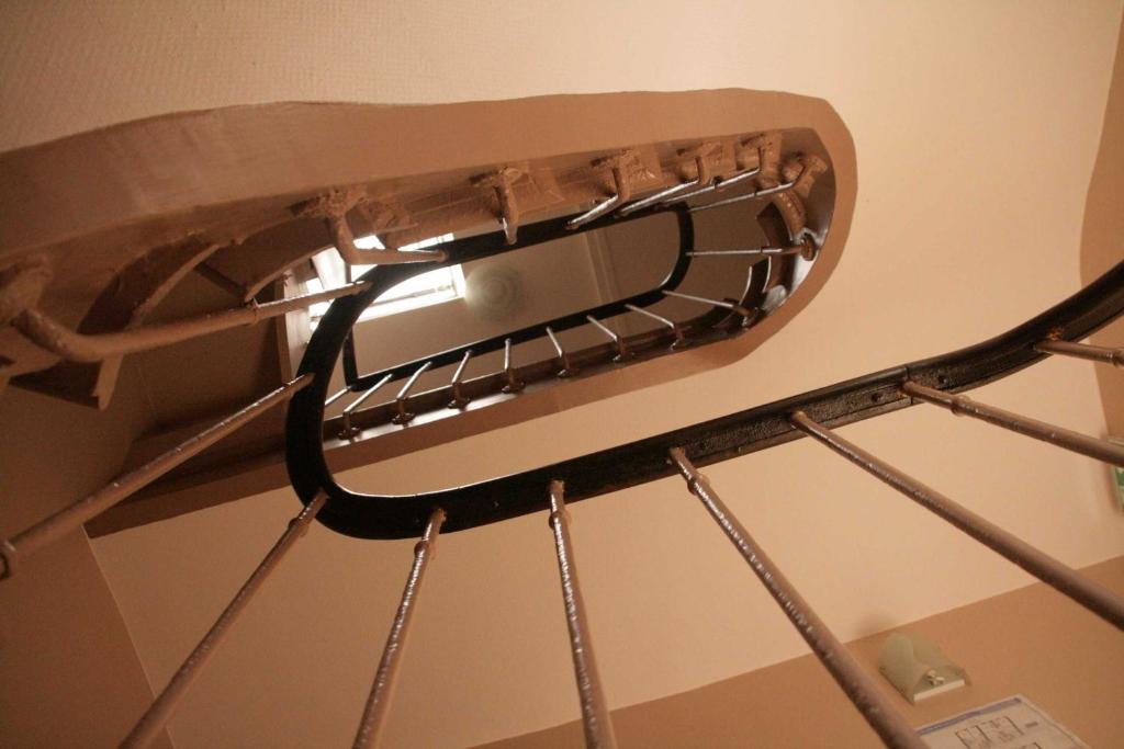 a ceiling fan hanging from the ceiling of a room at Hôtel du Roussillon in Paris