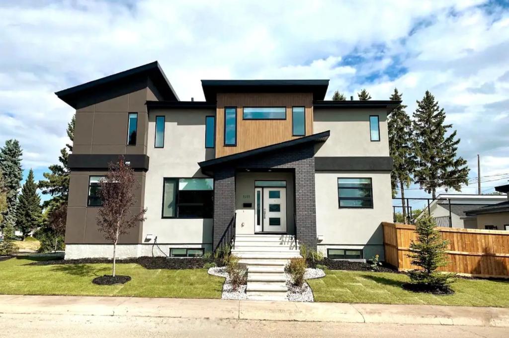 a large house on a street at Bright Modern Home - King Bed - Free Parking - Fireplace - Fast Wi-Fi - Free Netflix in Edmonton