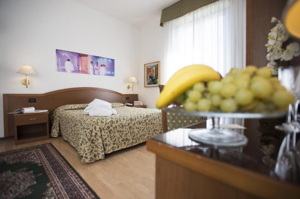 Postel nebo postele na pokoji v ubytování Hotel Angiolino