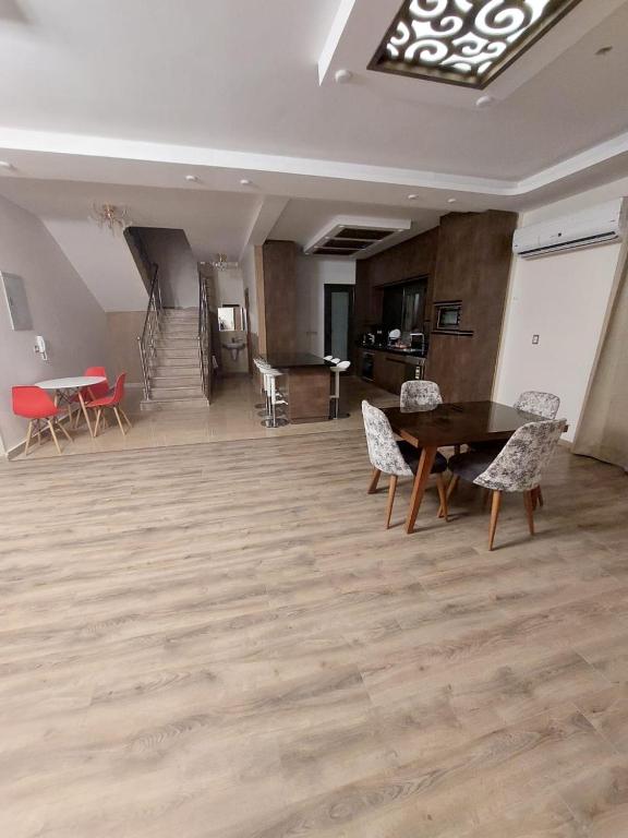 a living room with a table and chairs in a room at Near Mall Masr - Families only - 6 october - Luxury town house in 6th Of October