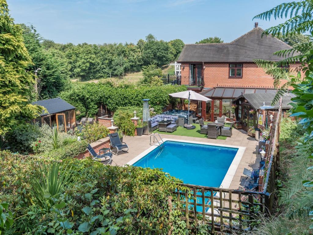 an aerial view of a house with a swimming pool at Freshwinds in Market Drayton