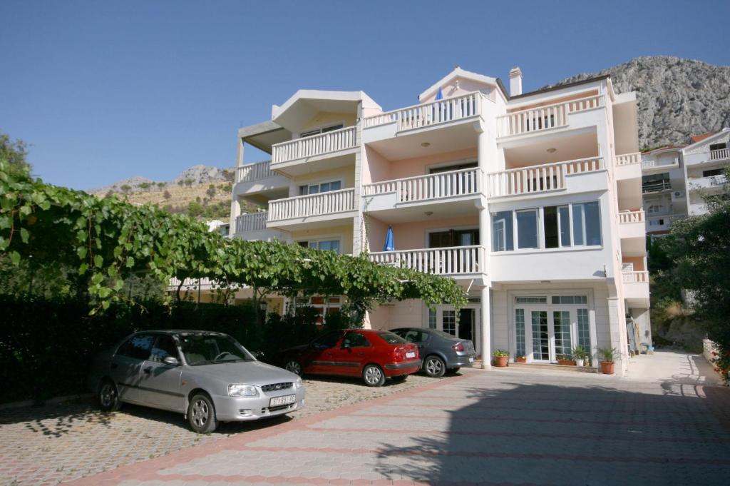 two cars parked in front of a building at Apartments with a parking space Duce, Omis - 4650 in Duće
