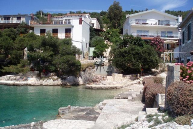 a group of houses and a river with buildings at Apartments by the sea Cove Jagodna - Brusje, Hvar - 4619 in Brusje
