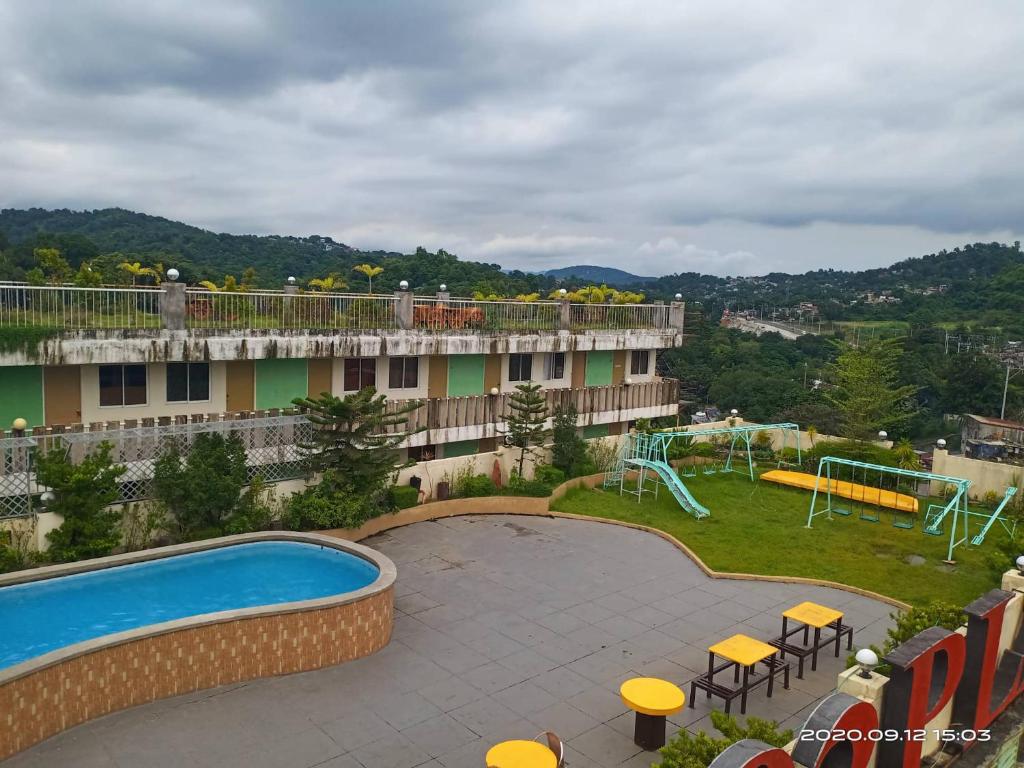 a resort with a swimming pool and a playground at 8 JOAQUIN'S Place WIFI Free! in Antipolo