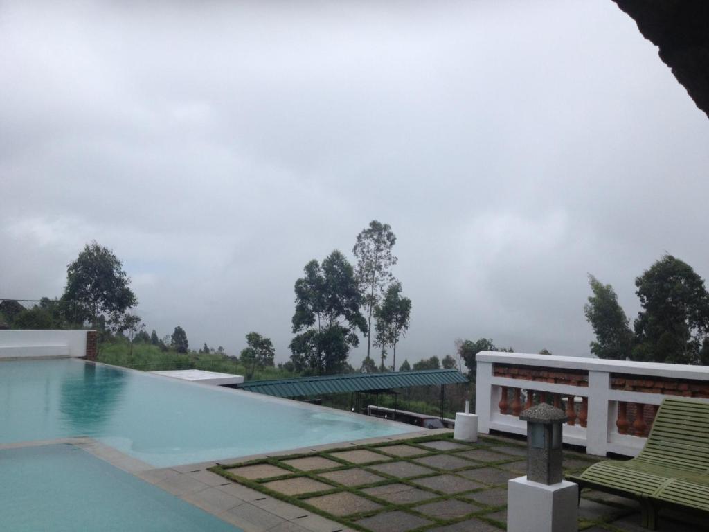a swimming pool on the roof of a house at Mountain Club Resort Munnar in Chinnakanal