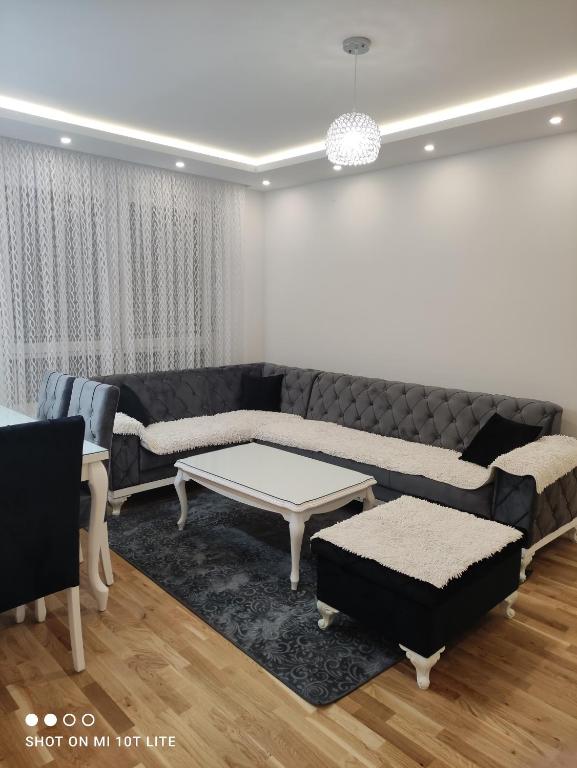 a living room with a couch and a coffee table at Apartman LUX in Bijeljina