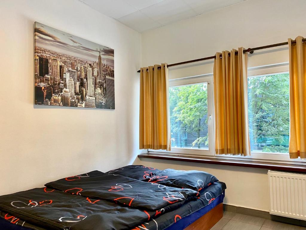 Posteľ alebo postele v izbe v ubytovaní Aparthotel Superjednostka Katowice