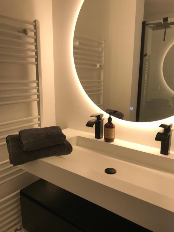 a bathroom with a sink and a mirror at BLOSS. in Ostend