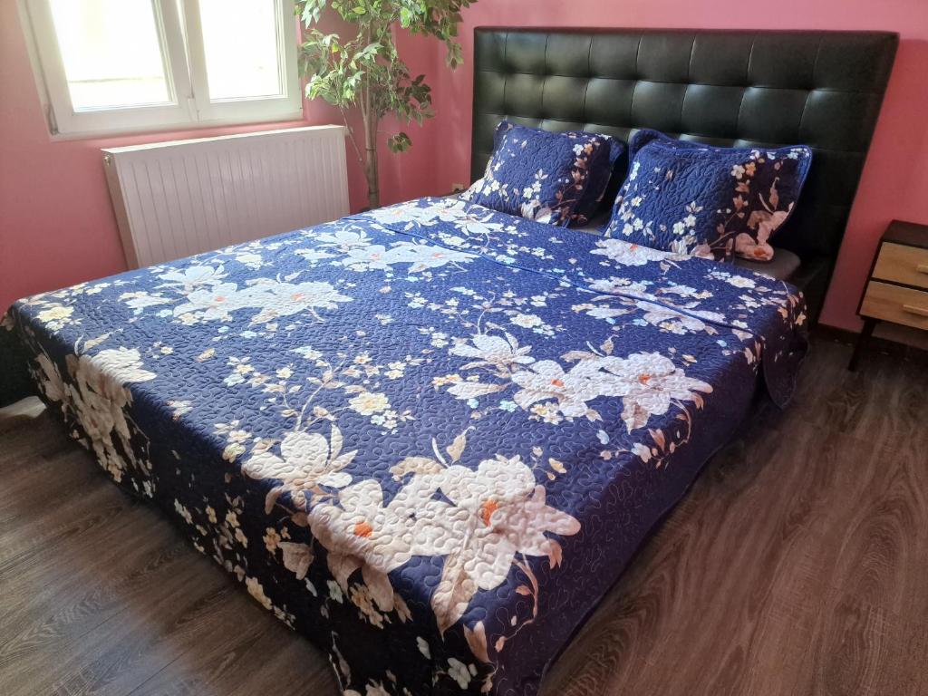 a bedroom with a bed with a blue comforter at Right choice room in Antwerp