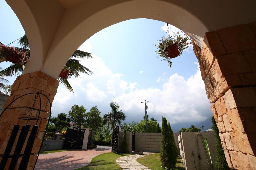 an archway with a fence and a cross in the background at White Palace B&amp;B in Ji&#39;an