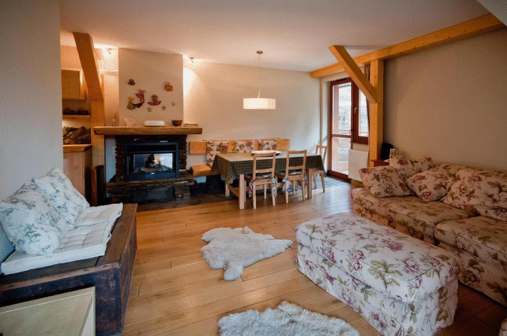 a living room with a couch and a fireplace at Apartments Zakopane Center in Zakopane