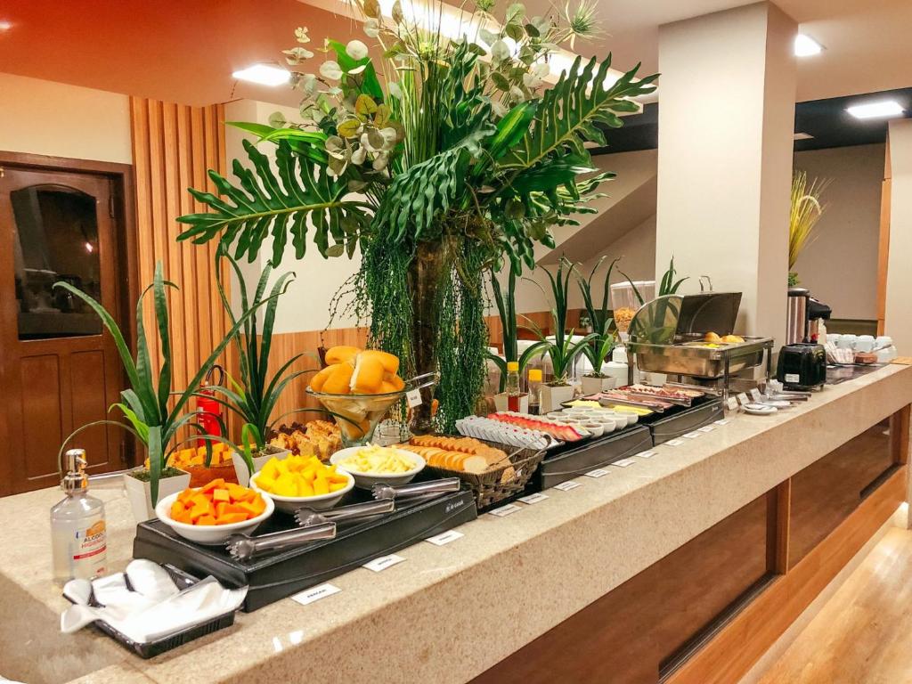 a buffet of food on a counter in a hotel at Presto Hotel in Blumenau