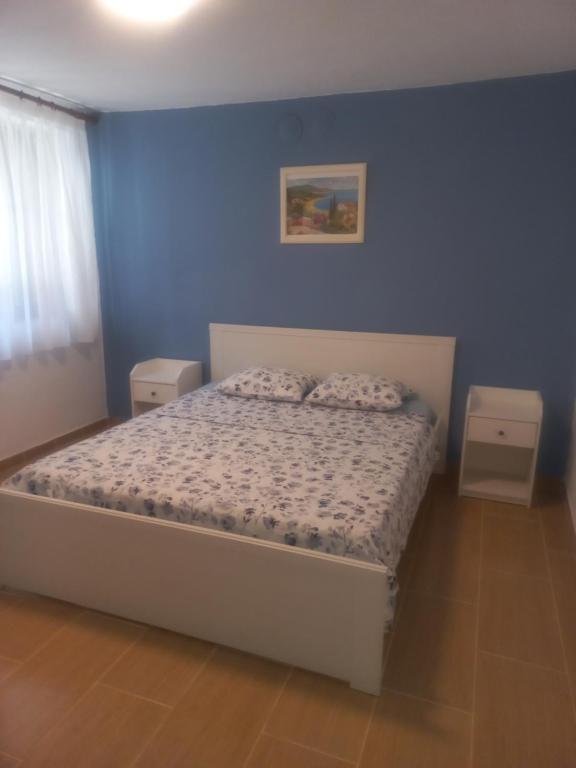 a bedroom with a bed with a blue wall at Apartment near Olympus mountain in Litochoro