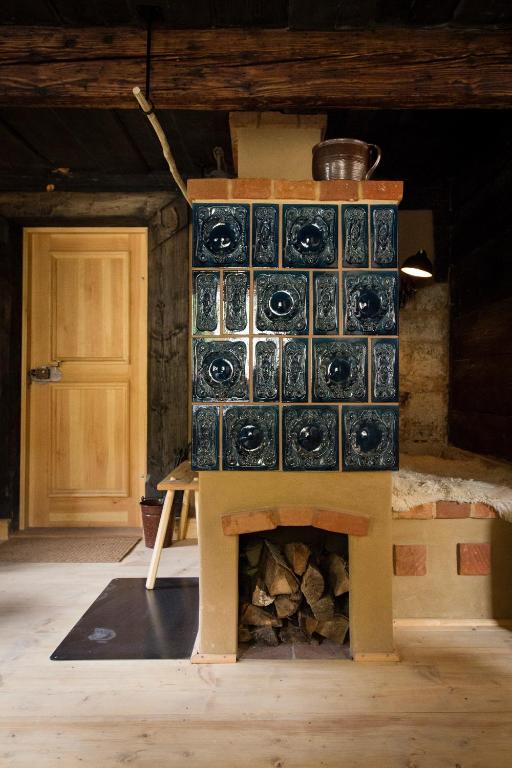 a fireplace with tiles on it in a room at Kulturdenkmal Umgebinde1657 in Bad Schandau