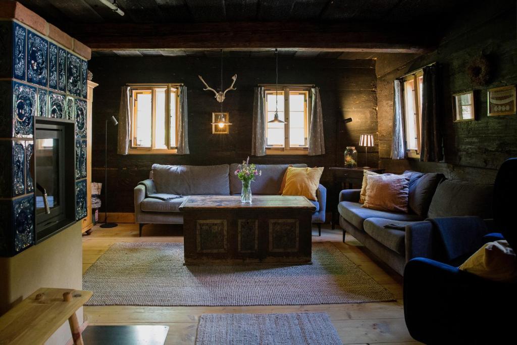 a living room with couches and a coffee table at Kulturdenkmal Umgebinde1657 in Bad Schandau