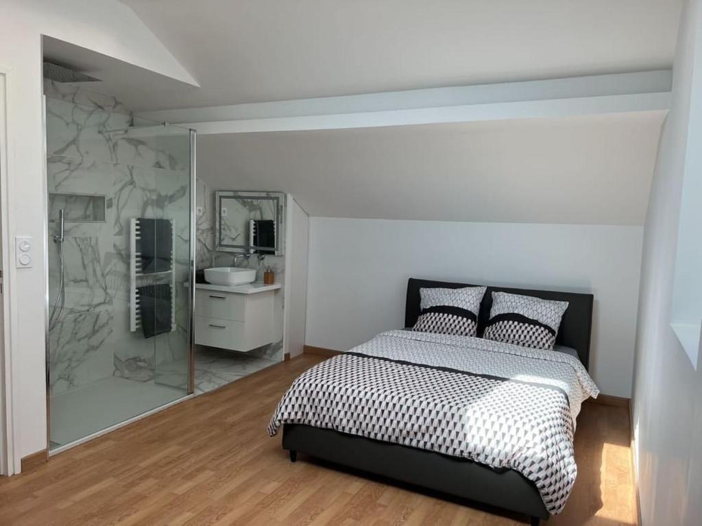 a bedroom with a bed and a bathroom with a mirror at Maison avec Jacuzzi Marseille in Marseille