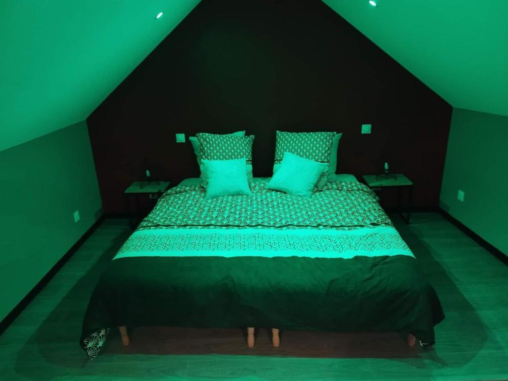 um quarto com uma cama grande e paredes verdes em Côté spa 
