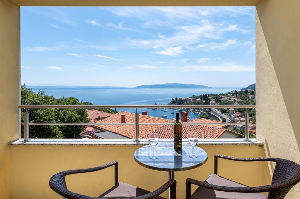 a table and two chairs on a balcony with a view at Apartment Igor in Ičići