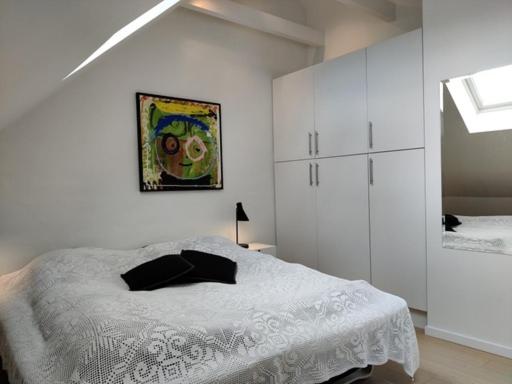 Uma cama ou camas num quarto em Værelser i midtbyen