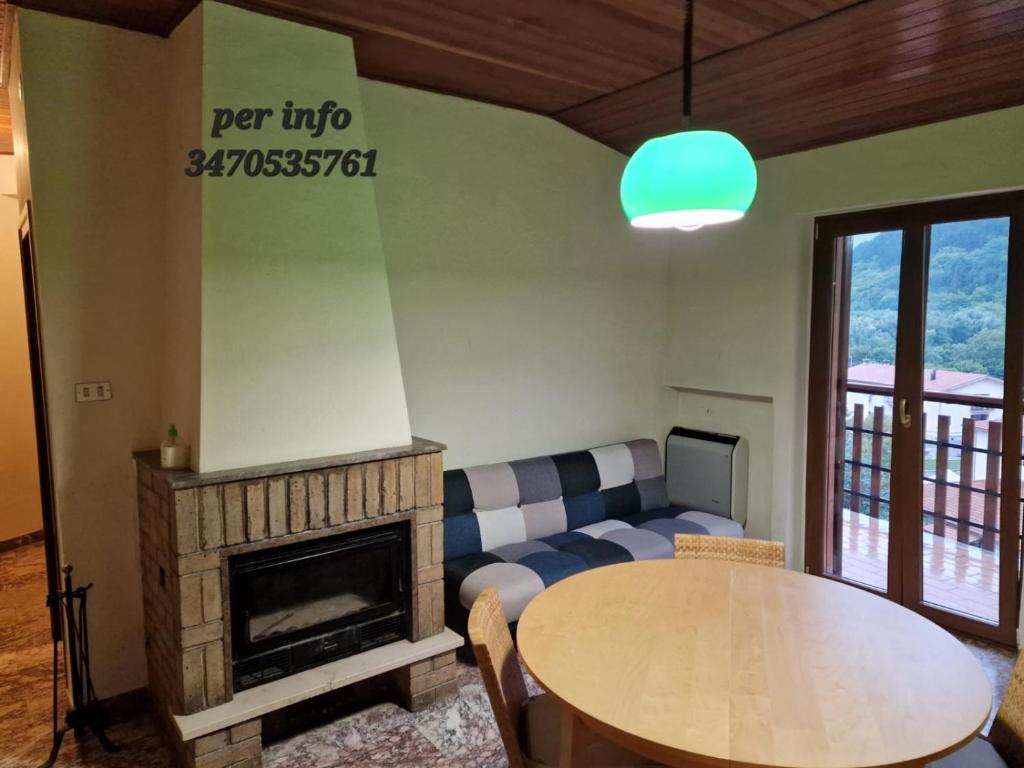 a living room with a couch and a table at luxury lake in Villetta Barrea