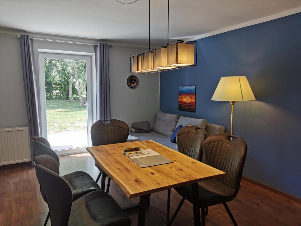 a dining room with a wooden table and chairs at 07 Birkenhain in Parchtitz