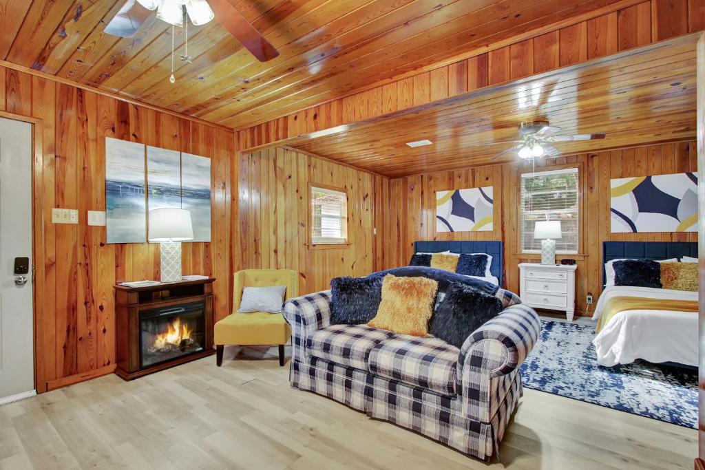 a bedroom with a couch and a bed and a fireplace at Lake Haven Cottage On Lake Hamilton in Hot Springs