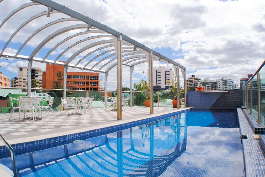 a large swimming pool in a large building at Best Western Astor Metropole in Brisbane