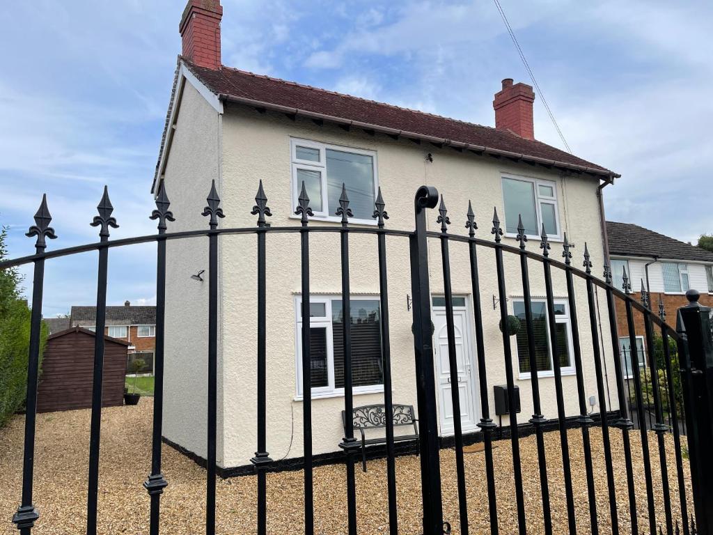a black fence in front of a house at Delightful 2 bed detached home with secure parking in Huntington