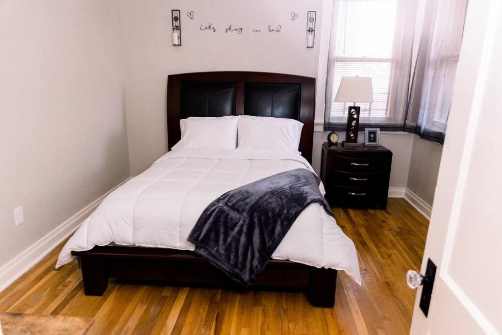 a bedroom with a large bed with a wooden floor at Chateaus at St Clair in Downtown Little Rock in Little Rock