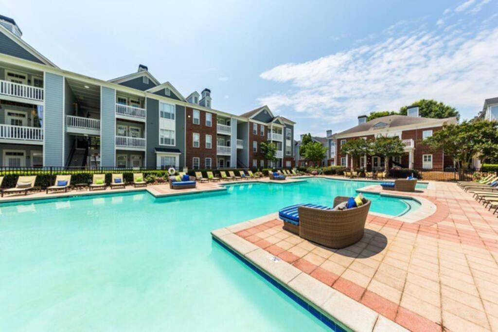 a swimming pool at a resort with lounge chairs at Heartbeat Of ATL- Gated Community, Pool, Gym, and much more! in Atlanta