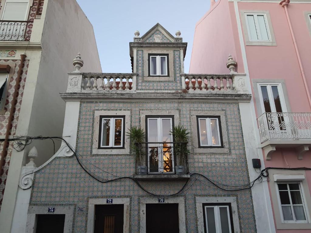 a building with a balcony on top of it at 1881 Historical duplex Suite in Lisbon
