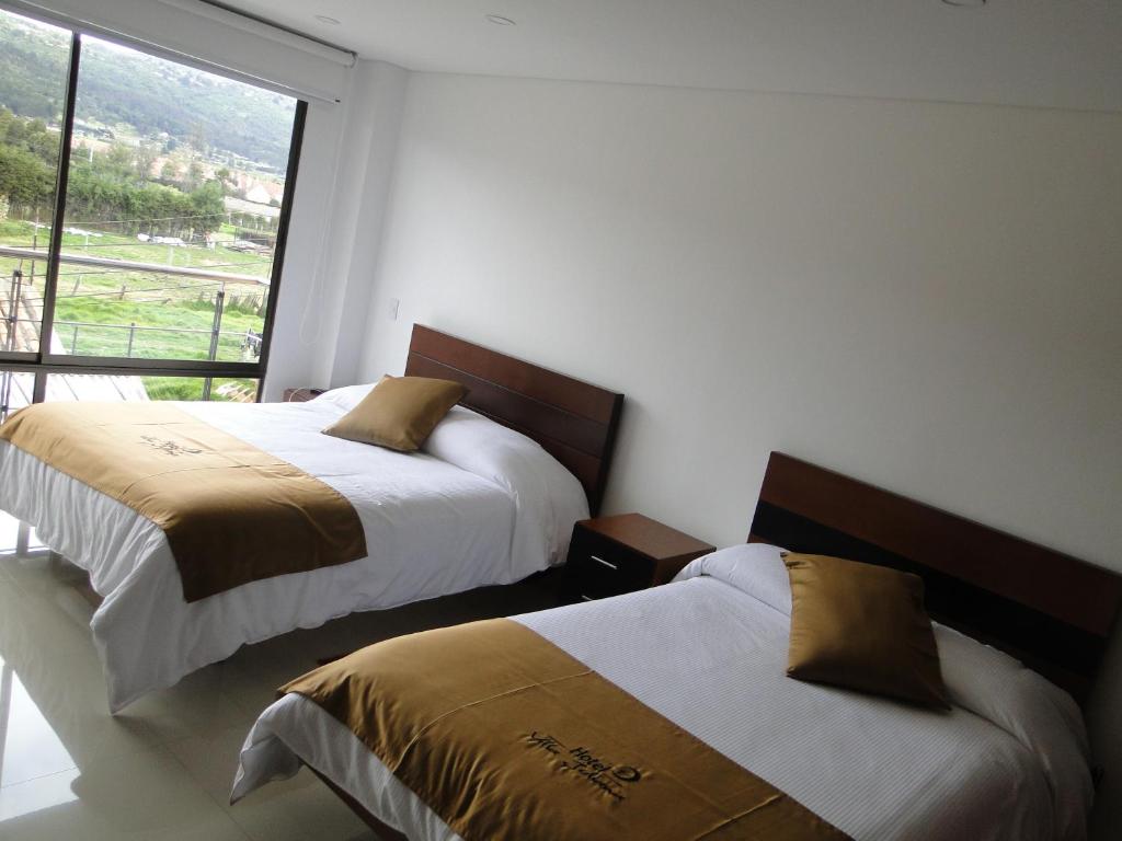 Postel nebo postele na pokoji v ubytování Hotel Campestre Villa Juliana