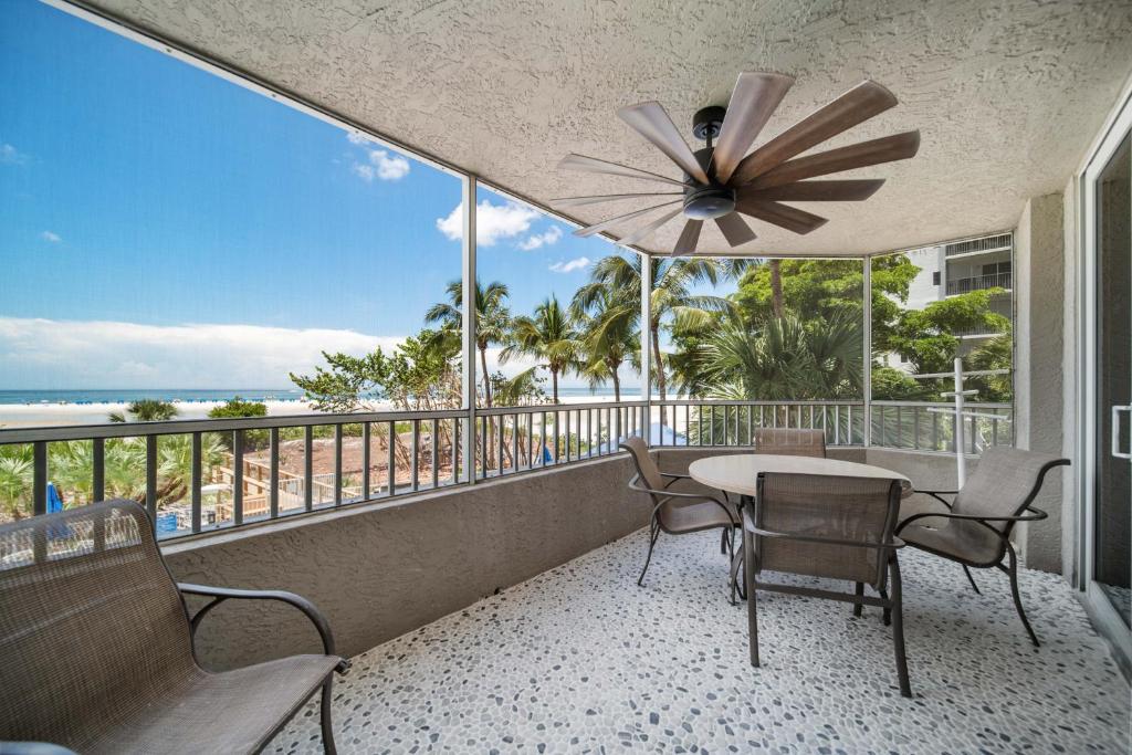 a balcony with a table and chairs and the ocean at Luxury Beach Front Resort in Fort Myers Beach