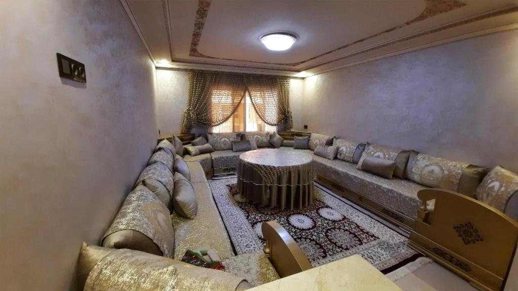 sala de estar amplia con sofá y mesa en اقامة ريان, en Nador