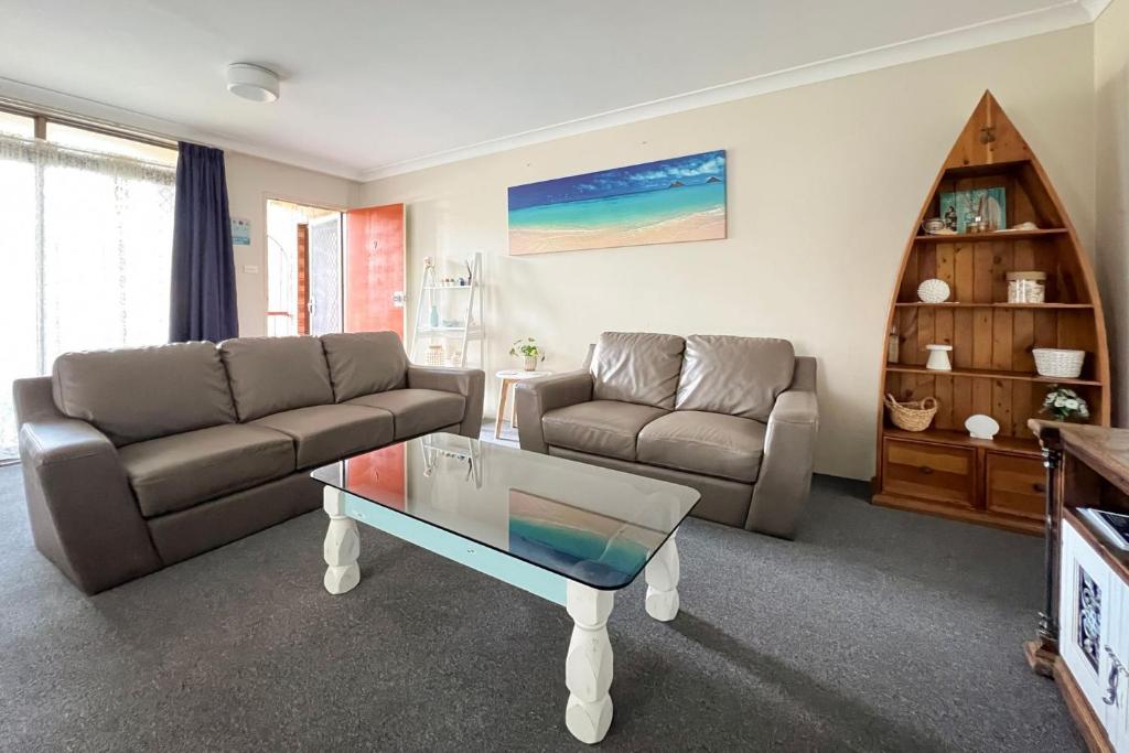 a living room with a couch and a coffee table at Braemar 9 in Forster