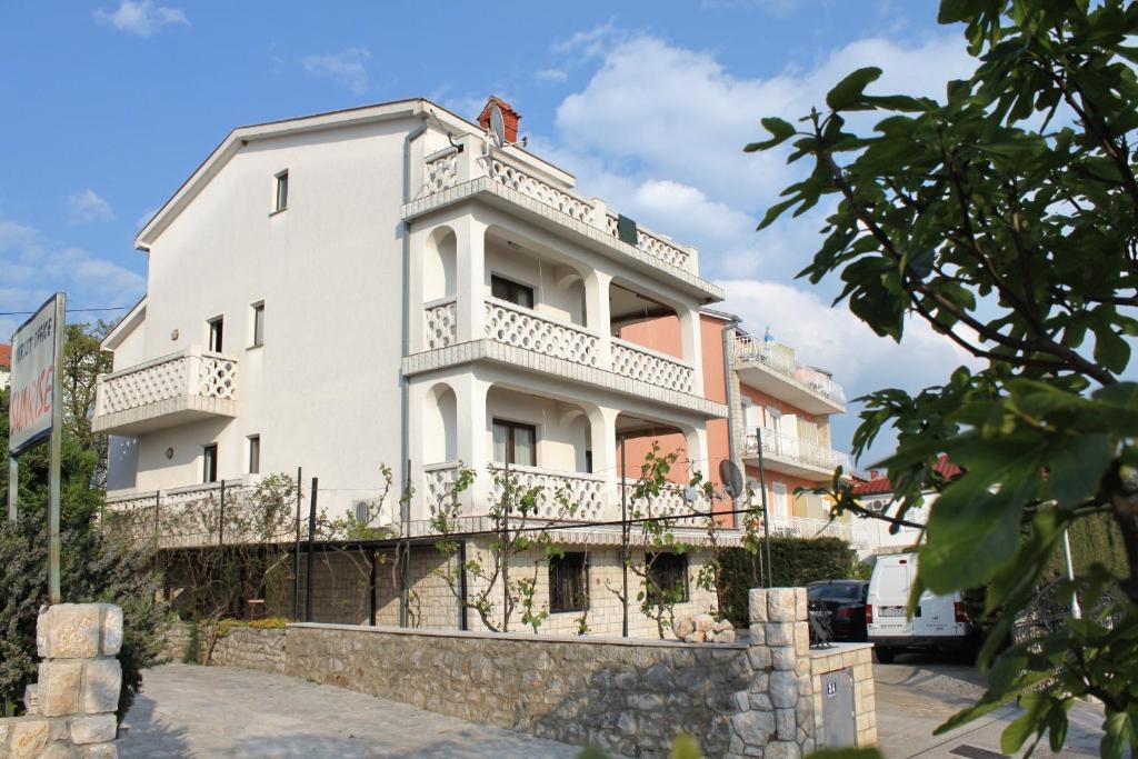 a white building with a balcony on top of it at Apartments with a parking space Selce, Crikvenica - 5287 in Selce